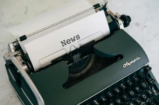 Typewriter with sheet that says news